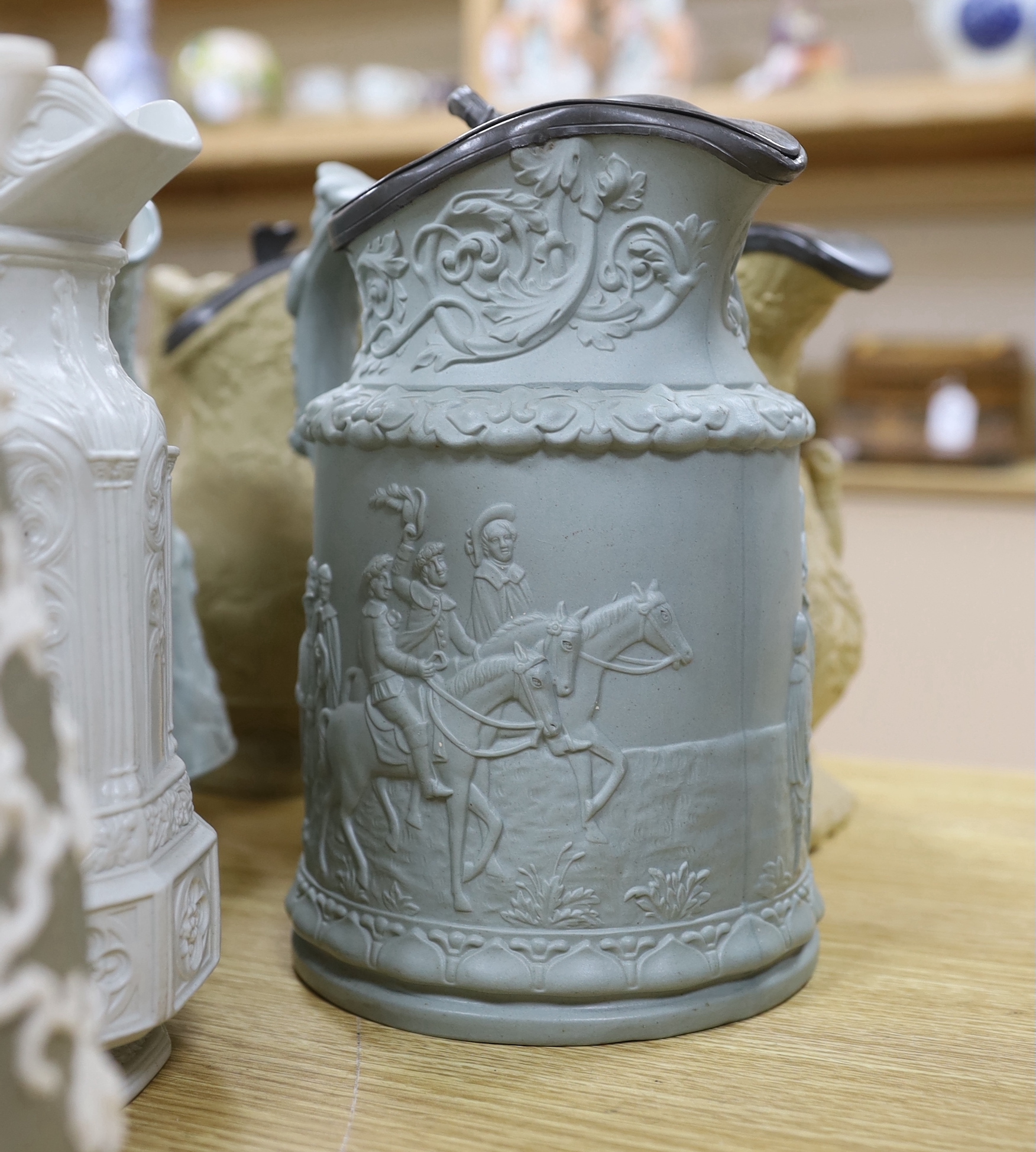 A collection of Victorian Charles Meigh and TJ & JM Mayers stoneware jugs, including Gothic relief designs, some with pewter lids, the largest 23cm high
